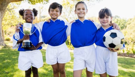 Youth football players holding a trophy